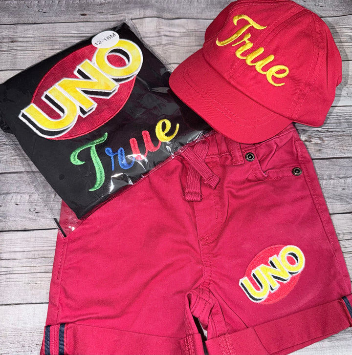 Personalized UNO birthday set for boys with a custom embroidered name shirt, colorful UNO design, red shorts, and coordinating UNO birthday hat.