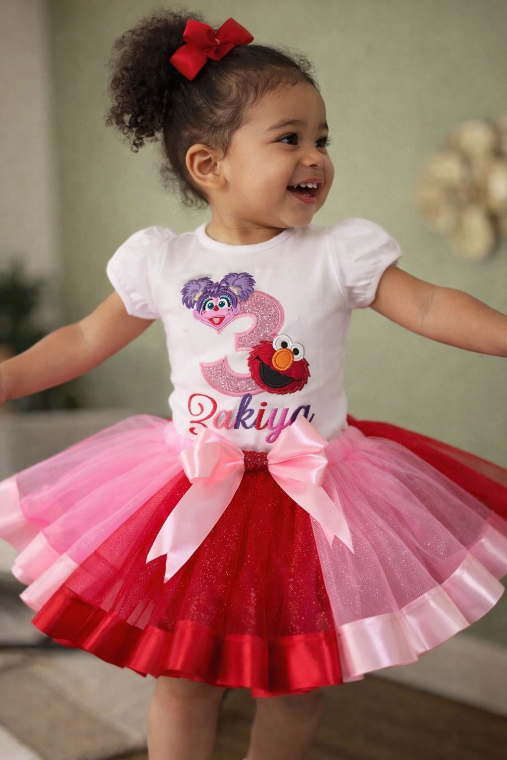 Child wearing a festive outfit with a tutu skirt and birthday-themed shirt.