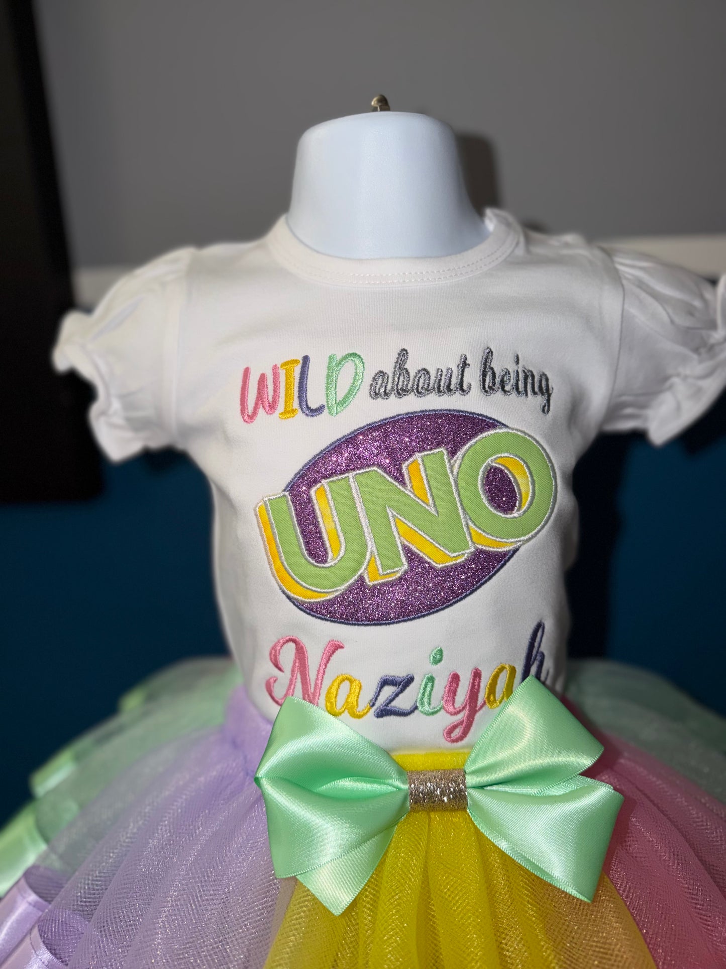 White shirt with colorful text on a mannequin against a dark background