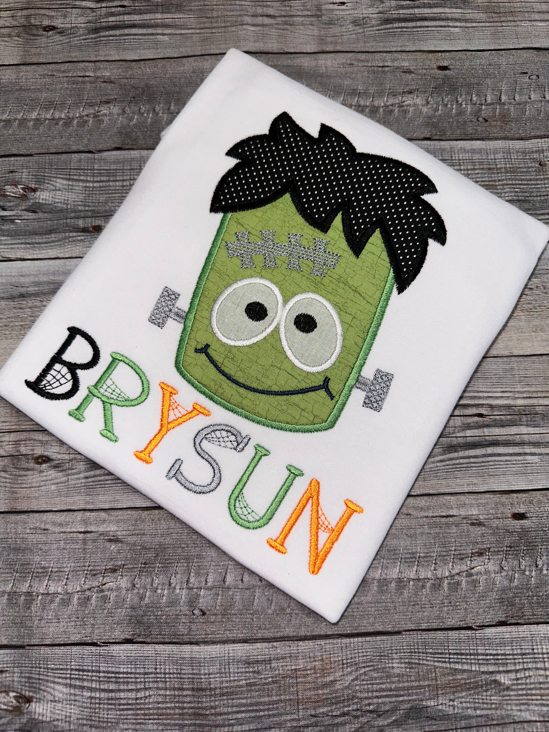 Frankenstein Halloween shirt featuring a cute embroidered monster design